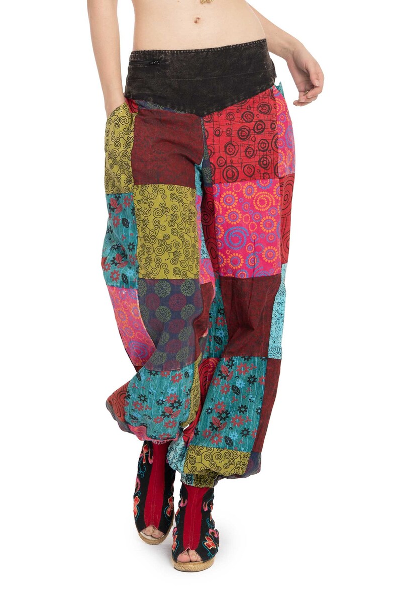 May include: Patchwork trousers with a colourful, geometric pattern. The trousers have a wide leg and a low rise. The fabric is a blend of cotton and linen.