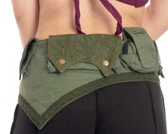 May include: A green canvas belt with multiple pockets and a lace detail. The belt has a triangular shape and is worn over black pants.