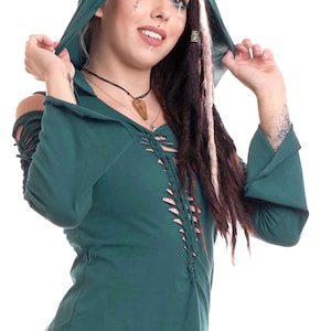 May include: A teal green hooded top with a lace-up detail at the front. The top has long sleeves with bell bottoms and a high neckline. The hood is pulled back to reveal the model's face.