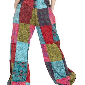 May include: Patchwork trousers with a colourful, geometric pattern in shades of red, green, blue, and pink. The trousers have a wide leg and a loose fit.