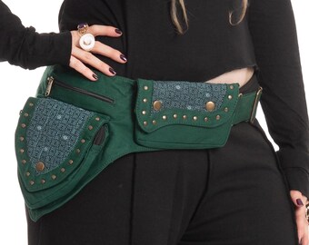 May include: A green fanny pack with two pockets and a patterned flap. The pack has brass-colored studs and a zipper closure. The fanny pack is worn around the waist.