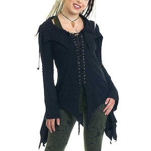 May include: A black long-sleeved tunic featuring a lace-up front closure with dark cord, a pointed collar, and an asymmetrical hemline. The garment is paired with olive green leggings that display a dark, repeating pattern of silhouetted birds.