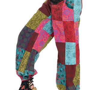 May include: Patchwork trousers with a colourful, geometric pattern. The trousers are made of a soft, comfortable fabric and have a loose, flowing fit.