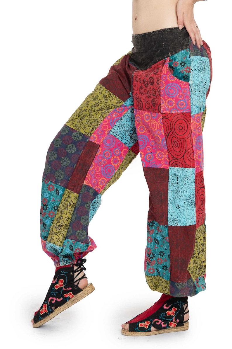 May include: Patchwork trousers with a colourful, geometric pattern. The trousers are made of a soft, comfortable fabric and have a loose, flowing fit.