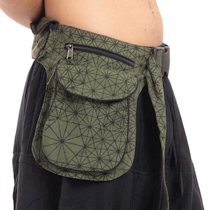 May include: An olive green utility belt with a black geometric starburst pattern. The belt features a large flap-covered pocket, a smaller zippered compartment, and a black plastic side-release buckle closure secured around the waist.