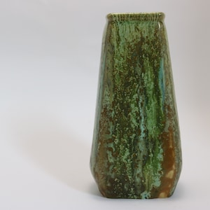 May include: A green and brown ceramic vase with a textured, mottled glaze.