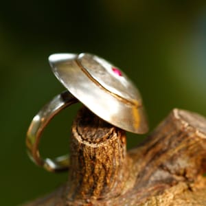 Hand made Silver sunrise ring with inlay of burgundy zircon