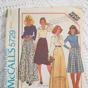 May include: Vintage McCall's 5729 sewing pattern for misses' skirts in two lengths. The cover shows illustrations of women wearing the skirts with different tops. The pattern includes the text "Quick & Easy".