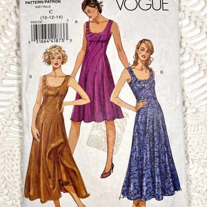 May include: A Vogue V8417 sewing pattern envelope featuring illustrations of three sleeveless dresses. One dress is solid purple, one is solid brown with a ruffled hem, and one is blue with a black floral pattern. The text V8417 is printed at the top.
