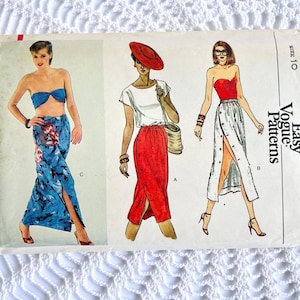 May include: A Very Easy Vogue Patterns sewing pattern envelope, number 7593, size 10. The front displays illustrations of three outfits: a blue patterned strapless top and skirt, a white top with a red button-front skirt, and a red top with a white skirt.
