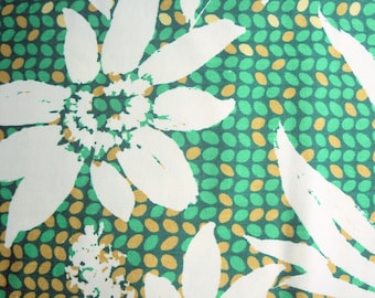 May include: White floral pattern on a green and gold background. The pattern is made up of stylized flowers with a central circle and petals.