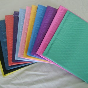 May include: A variety of colorful bubble mailers, including black, blue, red, pink, yellow, purple, and teal.
