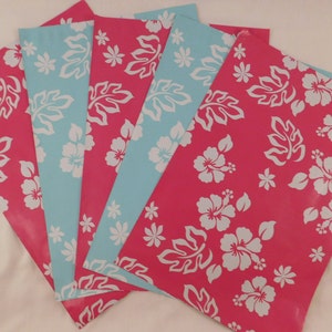 May include: Five sheets of wrapping paper with a tropical floral design. The paper is pink with white hibiscus flowers and leaves. Two sheets are light blue with white hibiscus flowers and leaves.