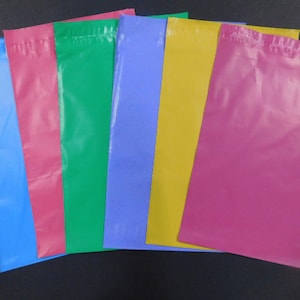 May include: Six plastic mailing envelopes in various colors: blue, pink, green, light blue, yellow, and magenta.