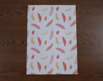 May include: White wrapping paper with a repeating pattern of orange, pink, and yellow feathers.