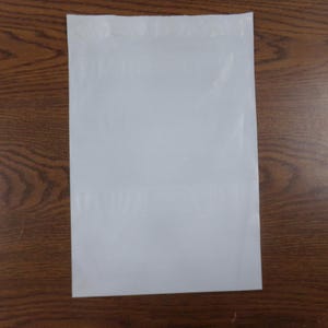 May include: A white plastic poly mailer envelope, commonly used for shipping small items.