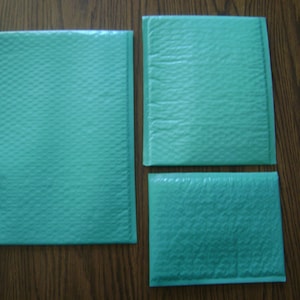 May include: Three teal blue padded mailing envelopes of different sizes. The envelopes are made of a bubble wrap material.