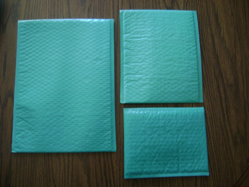 May include: Three teal blue padded mailing envelopes of different sizes. The envelopes are made of a bubble wrap material.