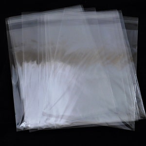 May include: A stack of clear plastic bags, likely for packaging small items.