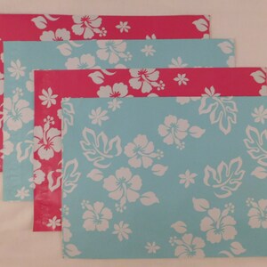 May include: Four colorful mailing envelopes with a tropical floral pattern. The envelopes are blue and pink with white hibiscus flowers.