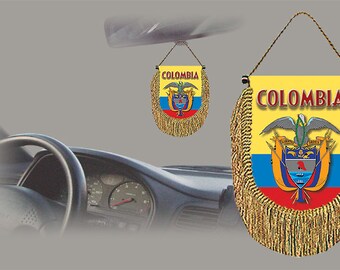 May include: A gold tassel car charm with the Colombian flag and the word "COLOMBIA" printed on it.