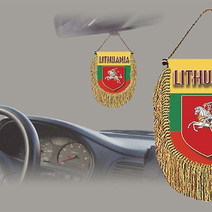 May include: A yellow and gold car hanging decoration with a red, green, and yellow Lithuanian flag and the word "Lithuania" printed on it.