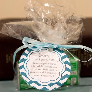 May include: A blue and white chevron patterned tag with the text "Chews... to read your scriptures. Chew one piece of gum a day while reading your scriptures. Read until the gum loses it's flavor. Enjoy your sweet reward."