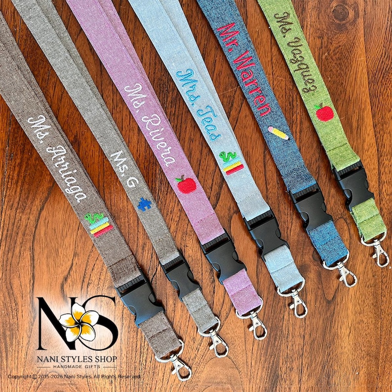 Assortment of breakaway safety lanyards made from a linen cotton blend fabric. Personalized with embroidery in a variety of fabric colors and embroidered icons.