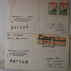 May include: A white ceramic mug with a black handle and the text "But First, Coffee" in a bold, black font. The mug is set against a blurred background, suggesting a cozy setting.