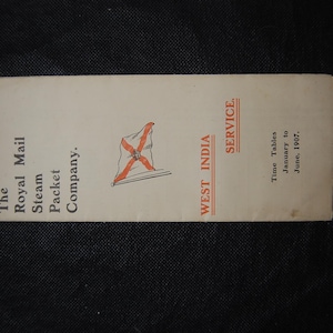 May include: A vintage pamphlet for the Royal Mail Steam Packet Company's West India Service. The cream-colored pamphlet features a flag emblem and text including "Time Tables January to June, 1907."