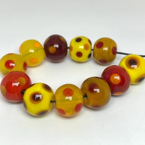Handmade yellow, red and orange spotted lamp work glass beads
