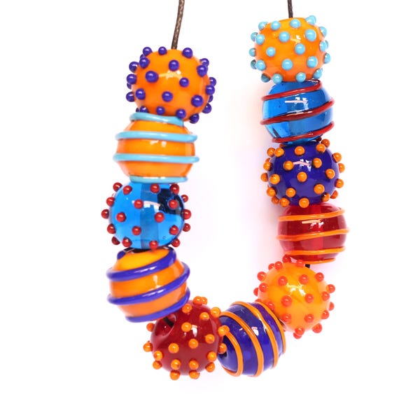 Handmade blue, red, orange and turquoise patterned lamp work glass beads