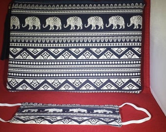 May include: A rectangular zippered pouch and a matching face mask, both featuring a dark blue fabric with a repeating white pattern of elephants and geometric shapes. The mask includes white elastic ear loops on each side.