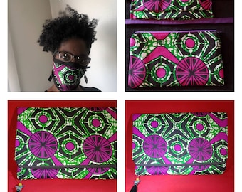 May include: A matching set featuring a face mask and a zippered pouch, both made from fabric with a geometric pattern in vibrant magenta, green, and black. The pouch includes a black tassel pull with a small bead accent.