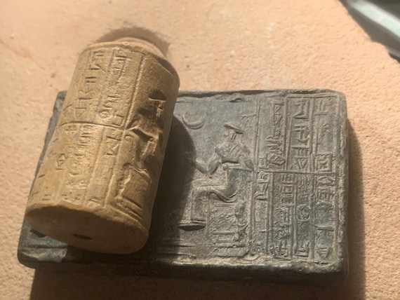 Sumerian cylinder seal of Ur Nammu. Museum replica tablet set. Mesopotamian art.