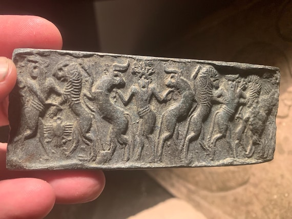 Sumerian cylinder seal impression - Master of animals. Museum replica