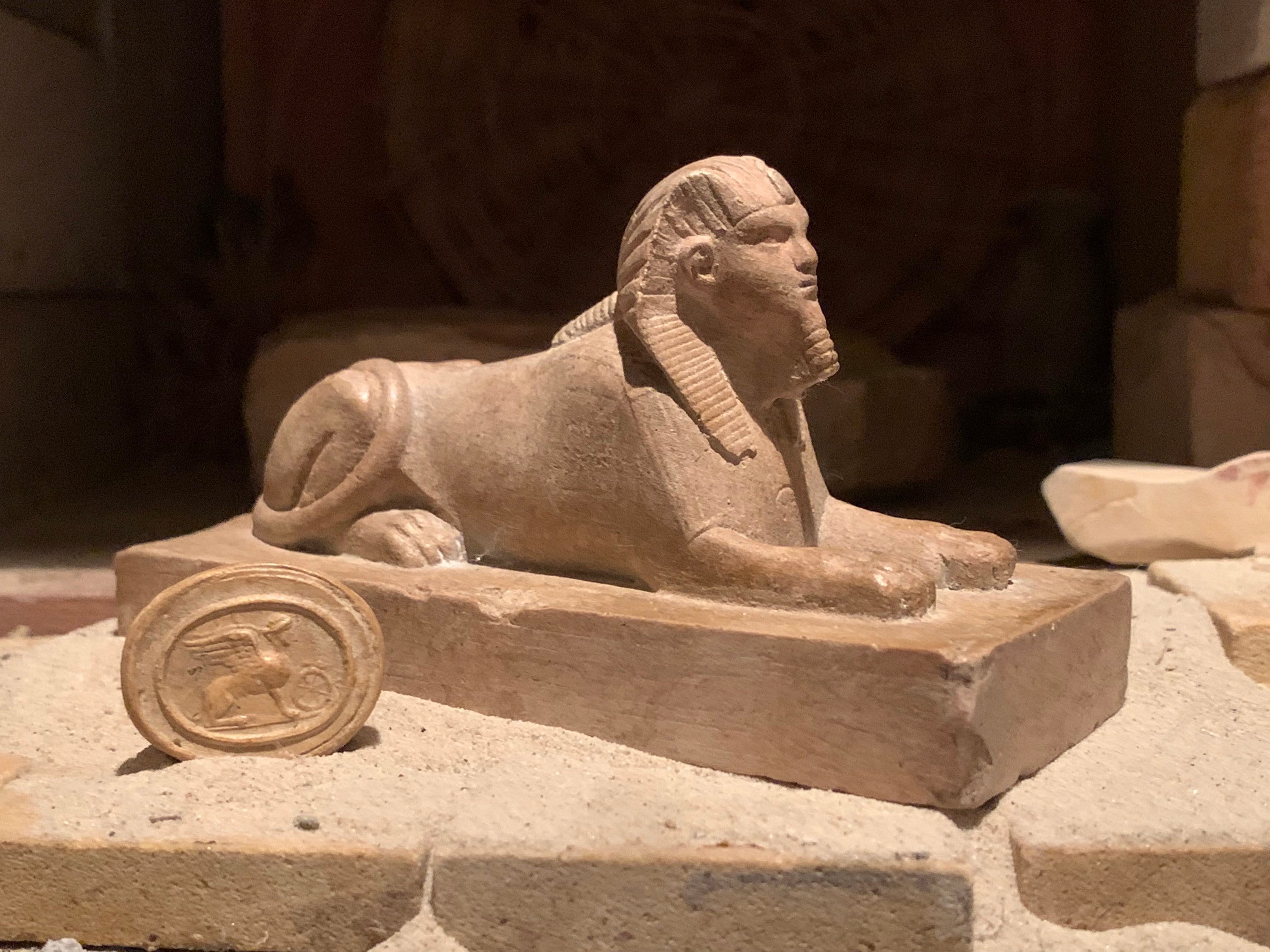 Egyptian Sphinx statue and amulet replica set. Egyptian sculpture and