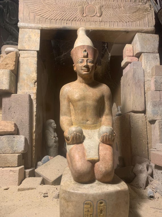 Egyptian statue of Amenhotep II kneeling with ‘Nu’ Jars and wearing the double crown