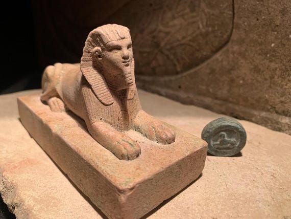 Egyptian Sphinx statue and amulet replica set. Egyptian sculpture and miniature relief