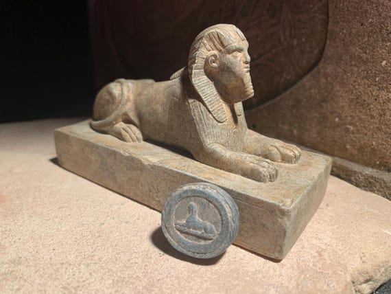 Egyptian Sphinx statue and amulet replica set. Egyptian sculpture and miniature relief