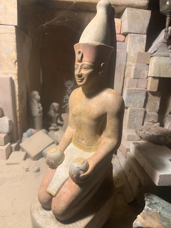 Egyptian statue of Amenhotep II kneeling with ‘Nu’ Jars and wearing the double crown