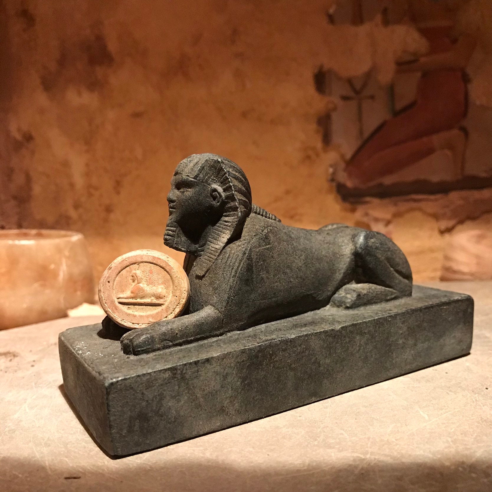 Egyptian Sphinx statue and amulet replica set. Egyptian sculpture and