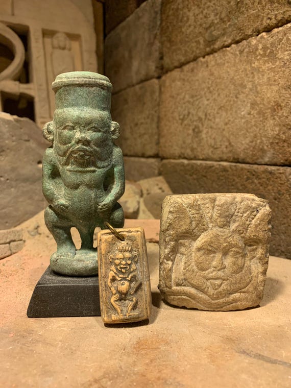 Egyptian statue of Bes and other protection amulets for home and childbirth.