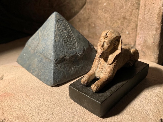 Egyptian sphinx statue  & pyramid featuring Tyet knot, lotus, Maat, cartouche