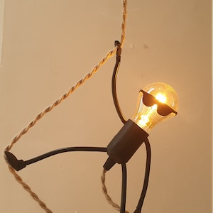 Mr.Bright WITH SUNGLASSES. Playful Pendant Light. Unique, fun and versatile! This 27 cm tall lively rope climber is an amazing eyecatcher.