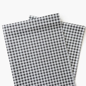 May include: Two sheets of black and white gingham tissue paper. The paper has a checkered pattern.