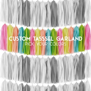 May include: A custom tassel garland with a variety of colors, including pink, yellow, green, blue, and orange. The text "CUSTOM TASSEL GARLAND PICK YOUR COLORS" is printed on the garland.