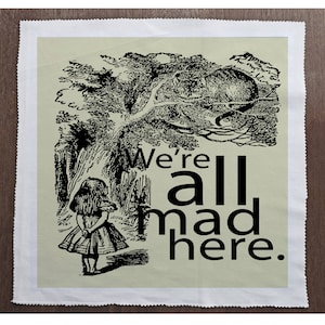 May include: A black and white illustration of Alice from Alice in Wonderland standing in a forest with the text "We're all mad here."