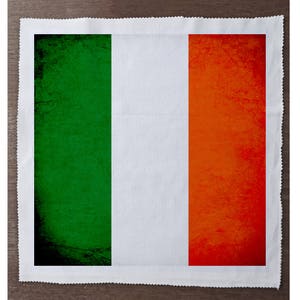 May include: A rectangular fabric napkin with a vintage-style Irish flag design. The flag features green, white, and orange stripes with a distressed texture.