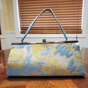 Bolso de mano con flores de chenilla azul bebé y amarillo de Glenda Gies con broche